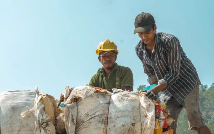 Workers loading baled collected plastic onto a truck in Kerala